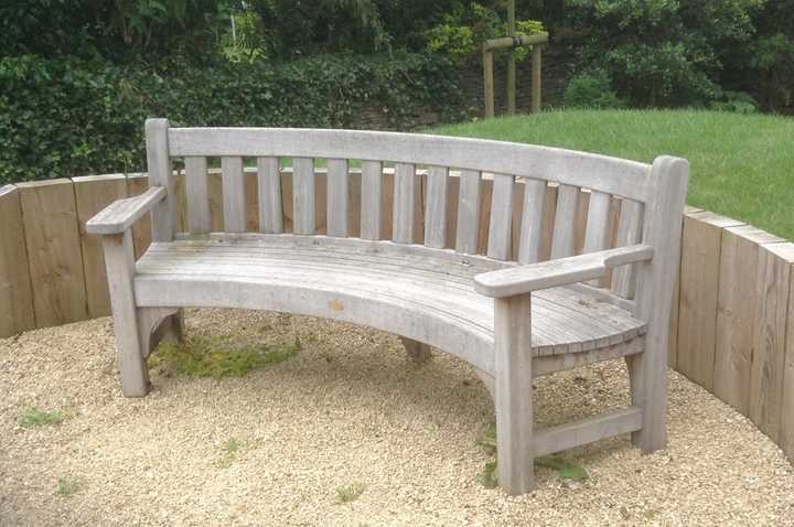 curved garden bench with back